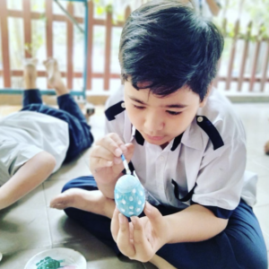 Boy Painting Egg Blue